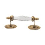 Elegant clear faceted crystal and brass pull handle with a 5-inch center on a dark wood cabinet