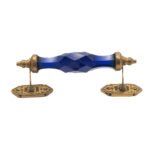Stunning blue crystal and brass pull handle with center on a classic white cabinet