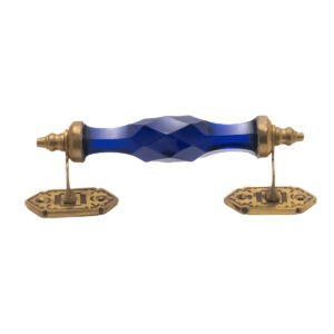 Stunning blue crystal and brass pull handle with center on a classic white cabinet