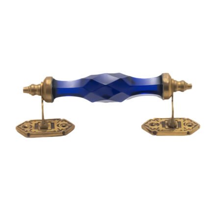 Stunning blue crystal and brass pull handle with center on a classic white cabinet