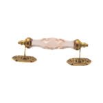 Chic pink crystal and brass pull handle with center on a white vanity drawer
