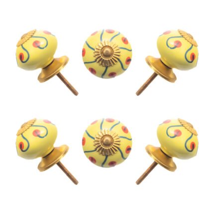 Sunny yellow hand-painted ceramic knob on a white kitchen cabinet