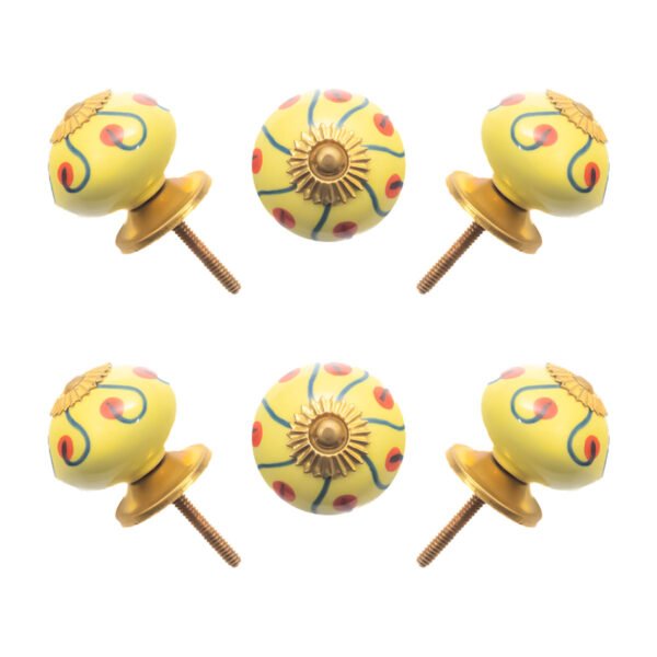 Sunny yellow hand-painted ceramic knob on a white kitchen cabinet