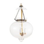 Large plain clear glass onion lantern chandelier with antique brass finish hanging in an entryway